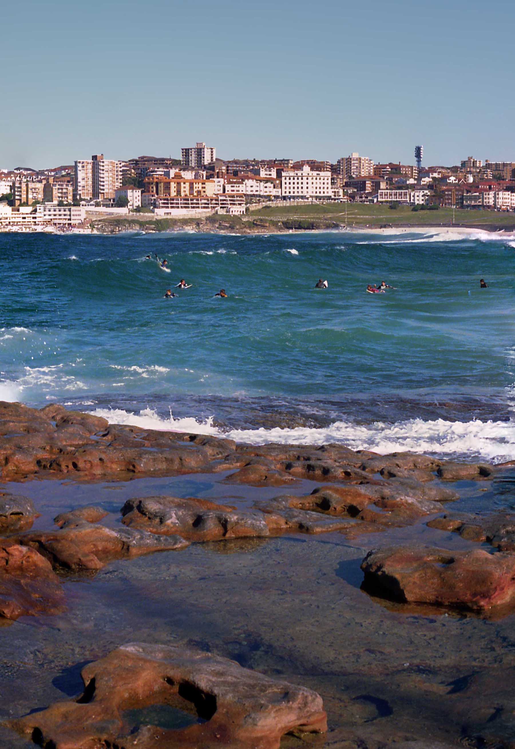 View of the surfers wearing wet suits at Bondi Beach on a chilly morning.