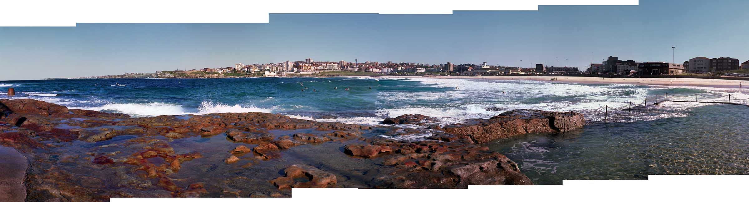 View of the surfers wearing wet suits at Bondi Beach from the North Bondi Rocks.