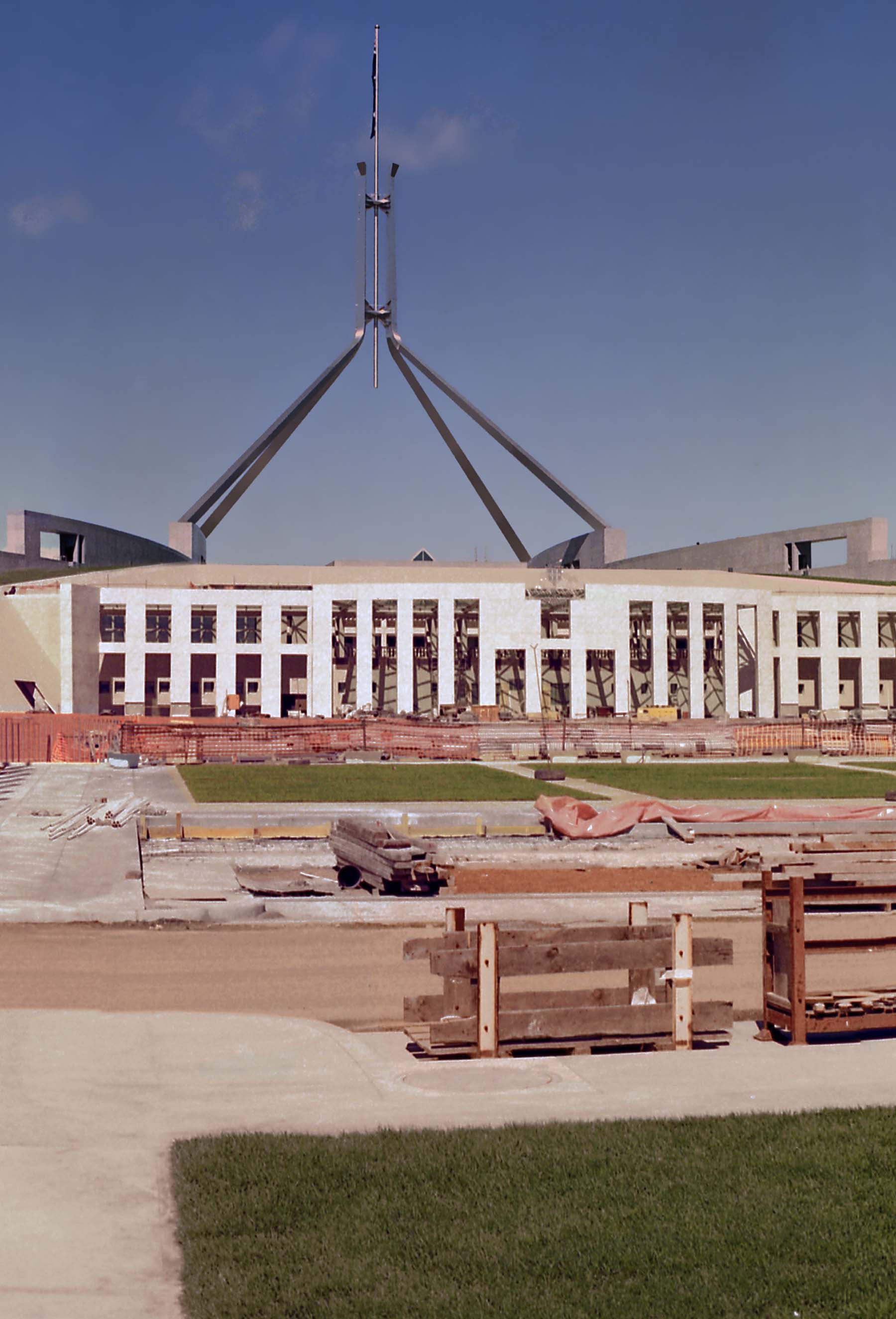 View of flagpole and entrance features to the new Parliament House, which was in the final stages of construction.