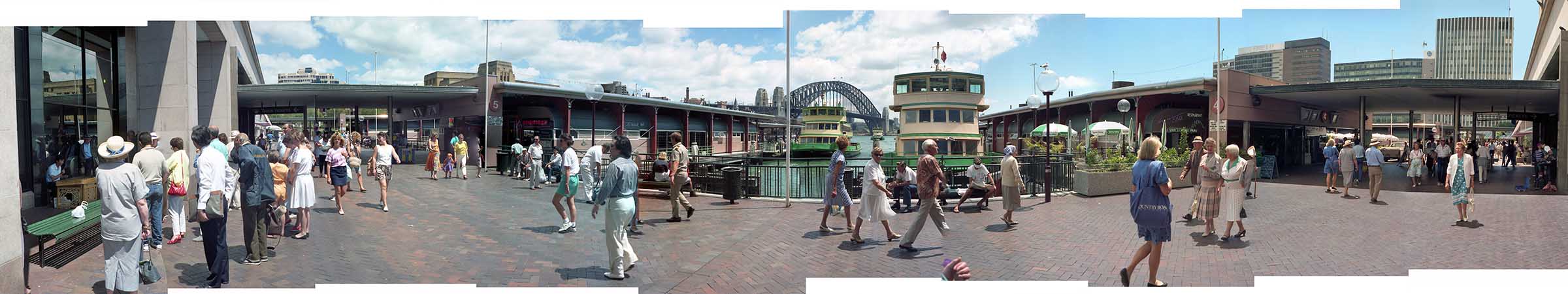 View of Circular Quay, ferries, and pedestrians at mid-day.