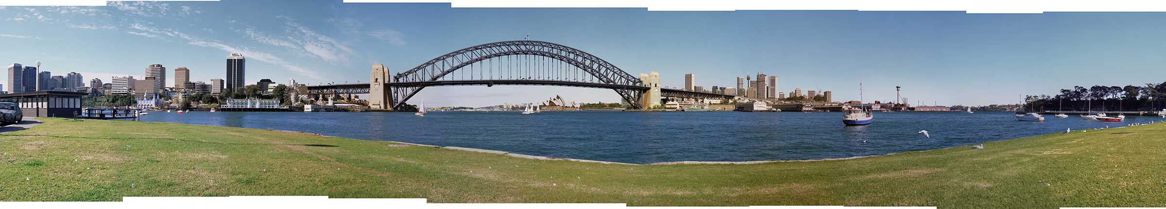 View of Sydney Harbour Bridge from McMahons Point, with views of the skylines of North Sydney and the city. 